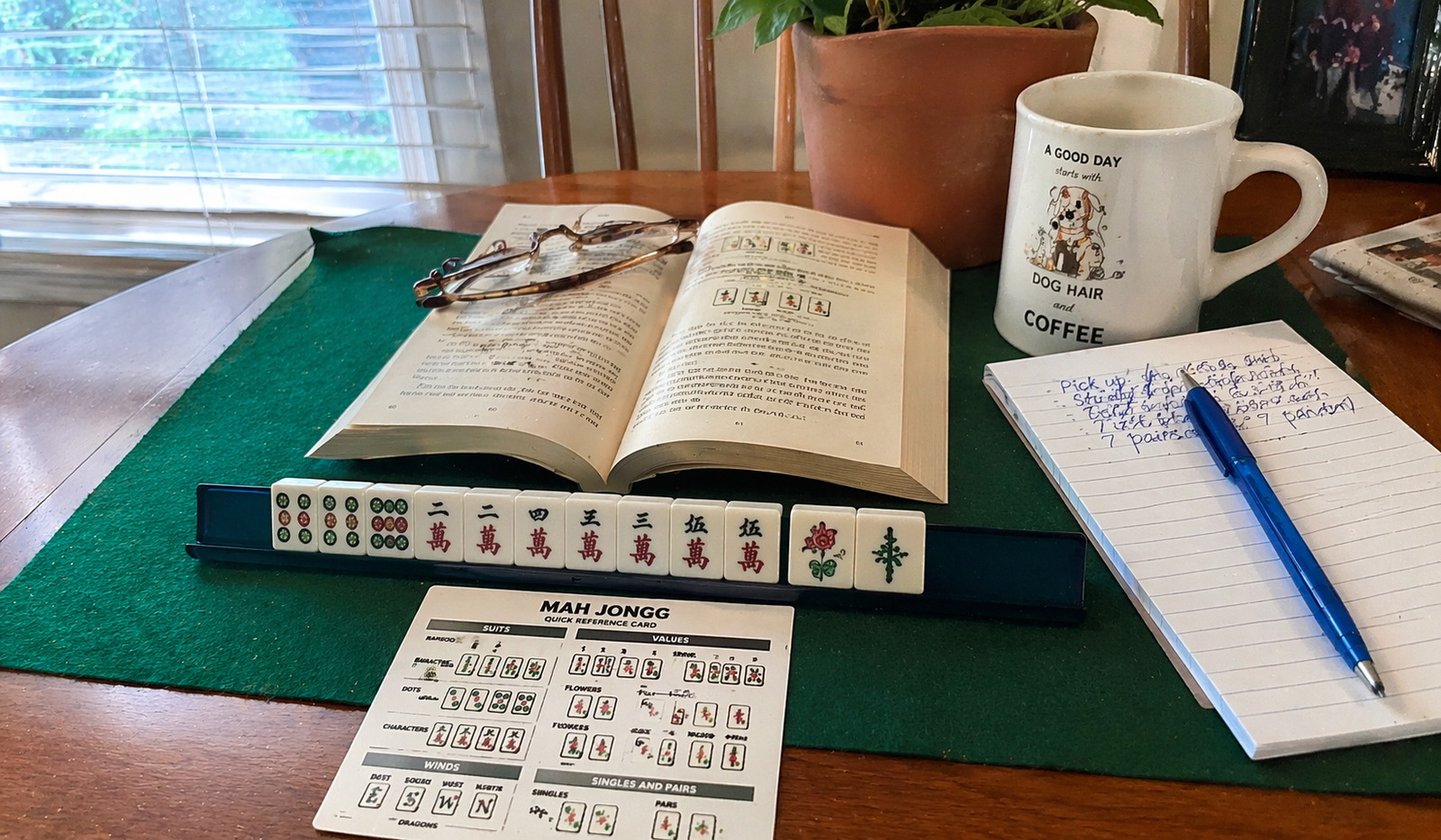 Mah Jongg tiles and strategy guide spread on a green felt table